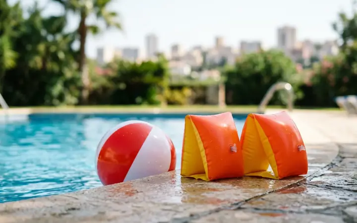 Children's floats by an outdoor pool (illustrative AI image)