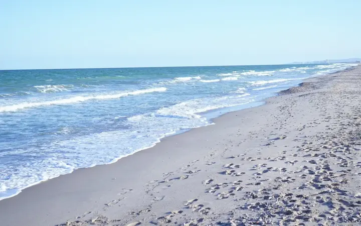 Waves on a wide sandy Mediterranean beach