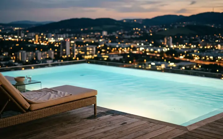 Rooftop pool and city lights at dusk (illustrative AI image)