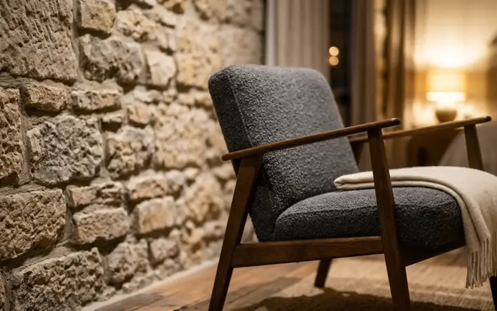 Ancient stone wall and a modern armchair (illustrative AI image)