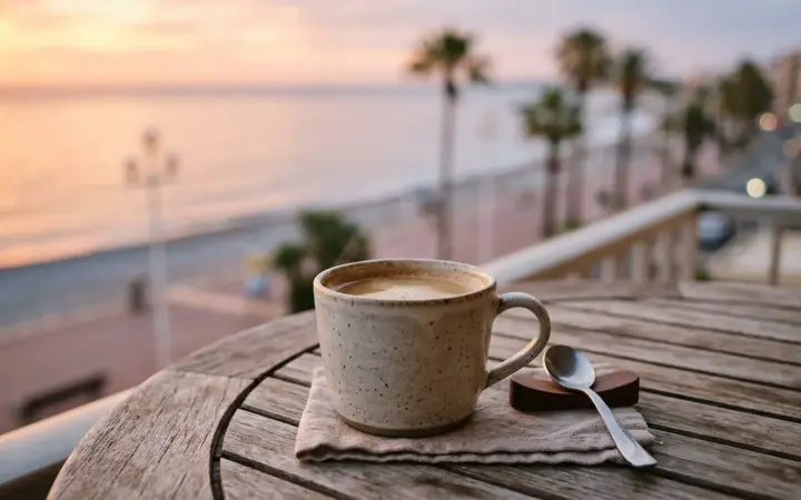 Sea-view balcony table at sunrise (illustrative AI image)